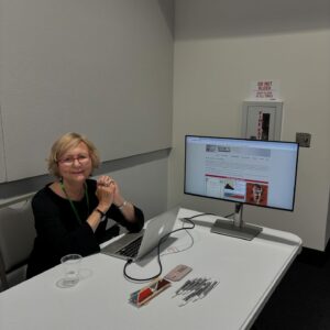 Photo of Pamela Caughie demonstrating the front page of the Modernist Networks website.